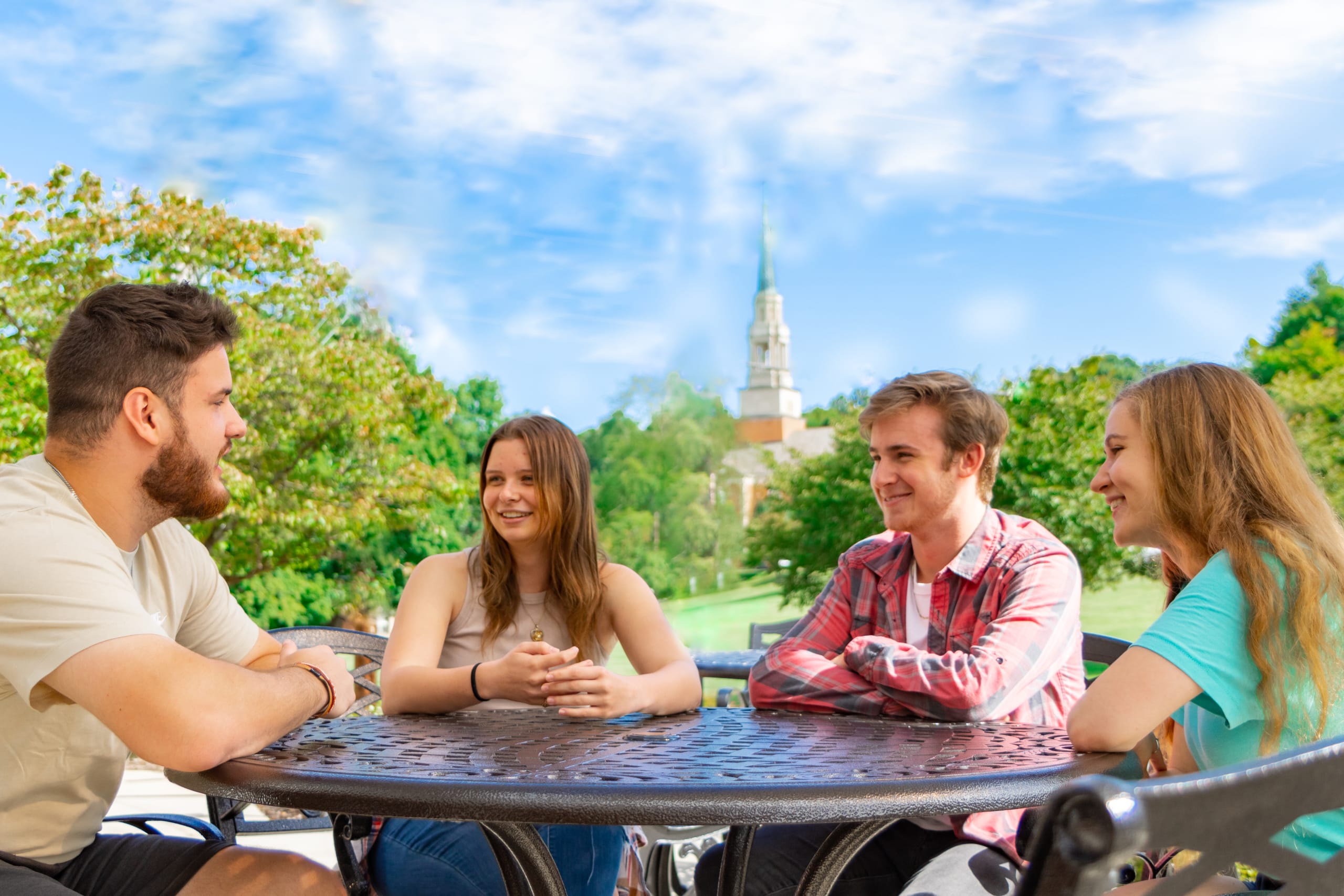 Students sitting outside of the SUB with Seeger in the distance